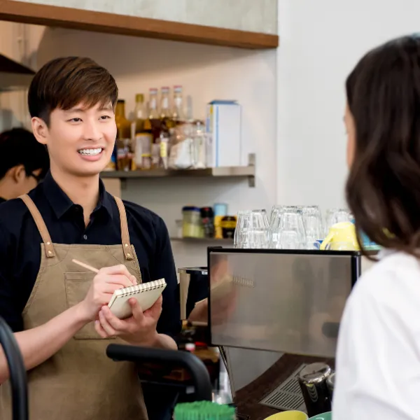 Colleagues from a range of backgrounds talking together in a retail workspace.