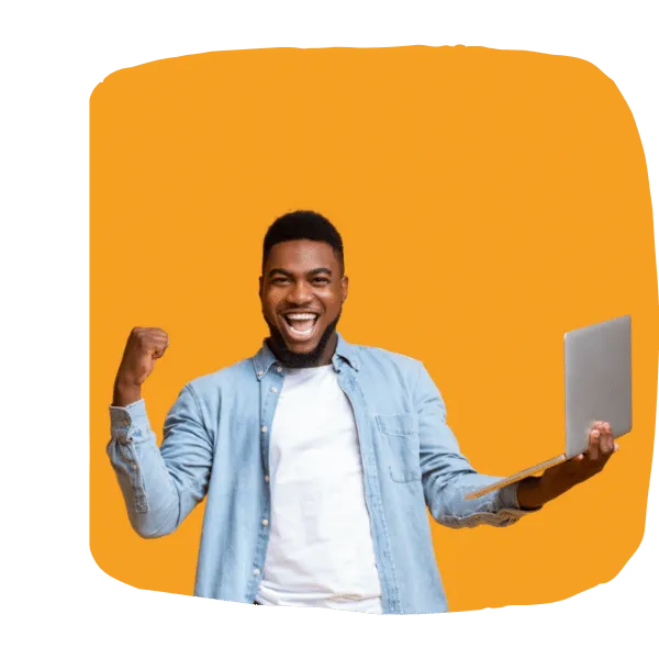 A salesperson smiling while working at a laptop.